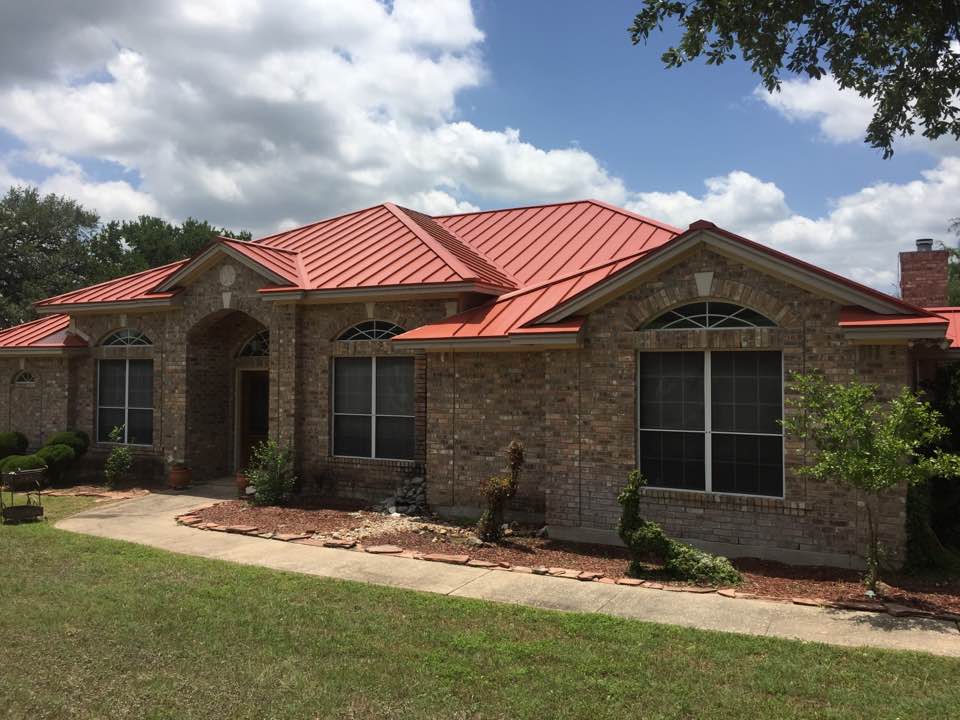 Large stone home with metal roof